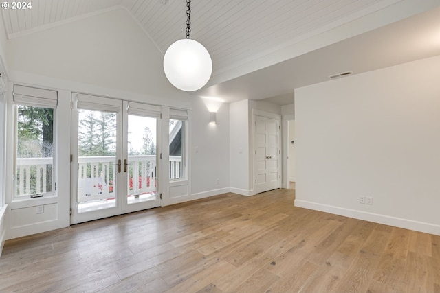 empty room with high vaulted ceiling, wood ceiling, light wood-type flooring, and french doors