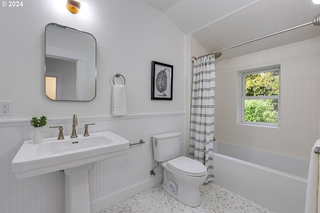 full bathroom with toilet, shower / bath combo with shower curtain, sink, and lofted ceiling