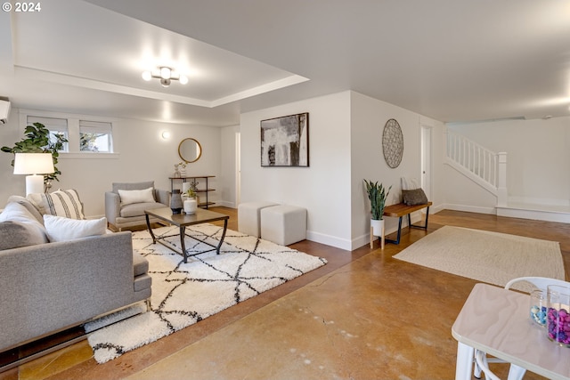 living room with a wall unit AC and concrete floors