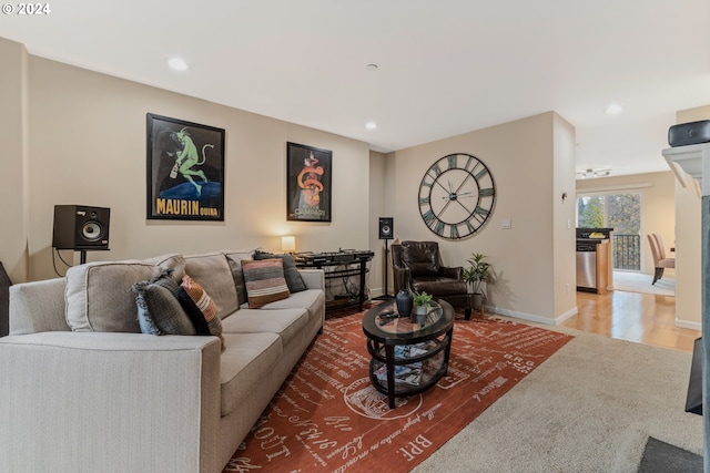 living room with recessed lighting, baseboards, and wood finished floors