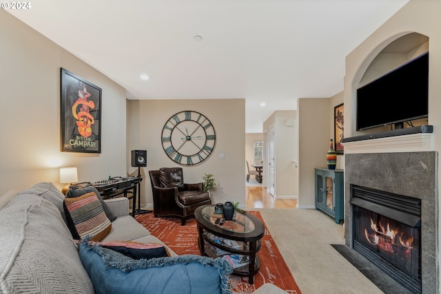 carpeted living room with recessed lighting, baseboards, and a high end fireplace