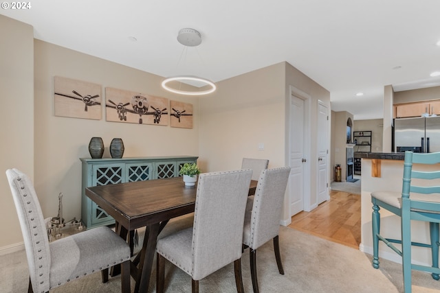 dining room featuring recessed lighting, light colored carpet, and baseboards