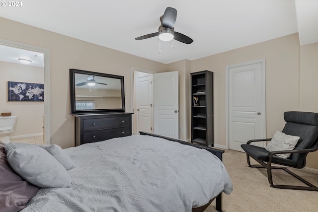 bedroom featuring ceiling fan, light colored carpet, baseboards, and connected bathroom