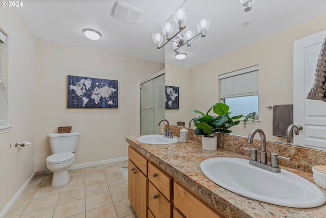 bathroom featuring a sink, visible vents, toilet, and tile patterned floors