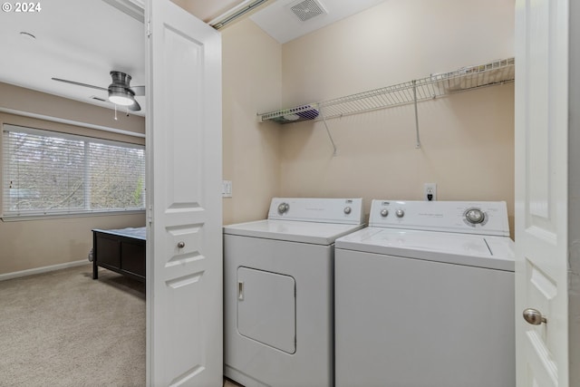 clothes washing area with visible vents, laundry area, ceiling fan, light colored carpet, and independent washer and dryer