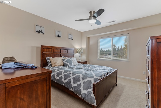 bedroom with visible vents, light carpet, baseboards, and a ceiling fan