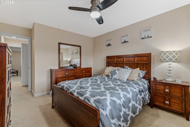 bedroom featuring a ceiling fan, baseboards, and light carpet