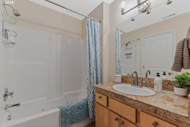 full bathroom with visible vents, vanity, and shower / tub combo