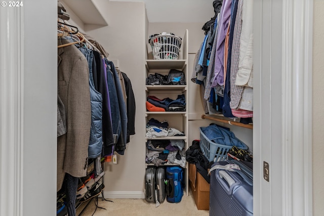 spacious closet featuring light carpet