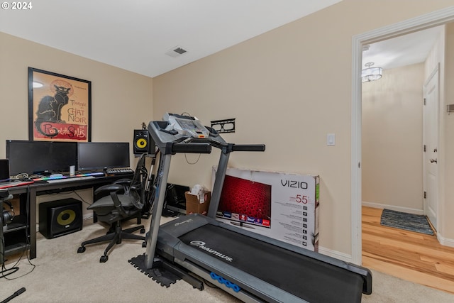 workout area with hardwood / wood-style floors