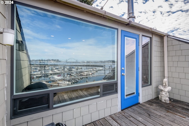 snow covered property entrance featuring a deck