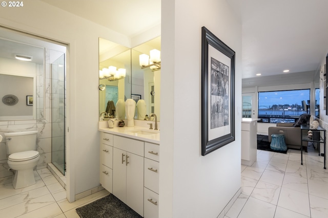 bathroom with tile walls, a chandelier, vanity, a shower with shower door, and toilet