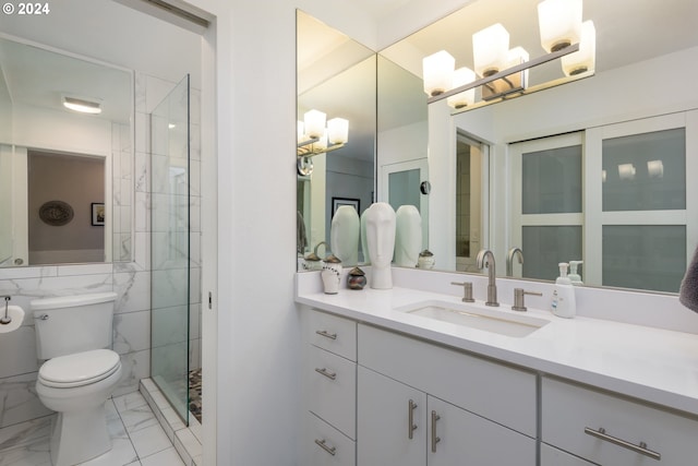 bathroom featuring tiled shower, vanity, and toilet