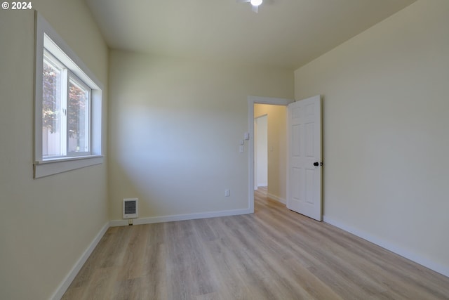 spare room with light hardwood / wood-style flooring