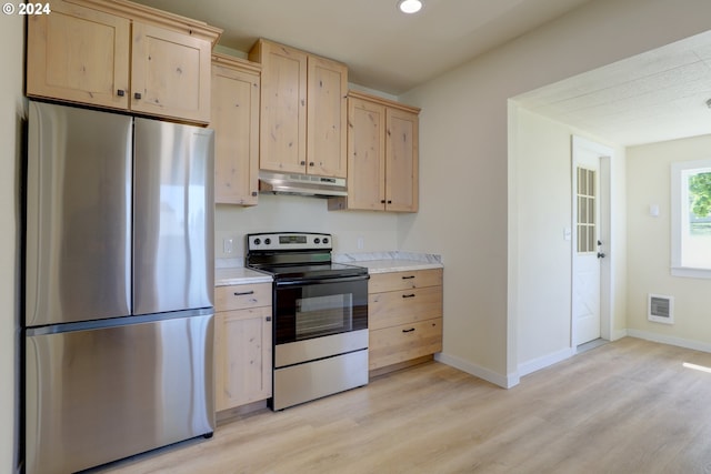 kitchen with light brown cabinetry, light wood-type flooring, and stainless steel appliances