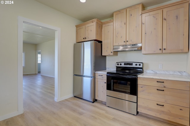 kitchen featuring light brown cabinetry, stainless steel appliances, and light wood-type flooring