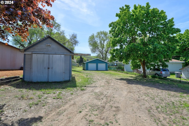 view of yard with a storage shed and a garage