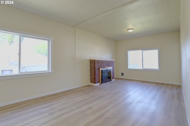 unfurnished living room with light hardwood / wood-style floors and a wealth of natural light