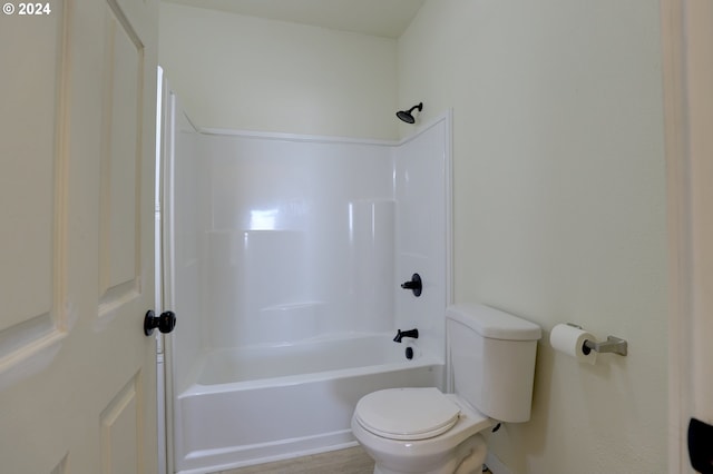 bathroom featuring shower / bath combination and toilet