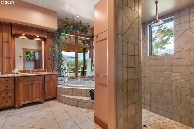 bathroom featuring shower with separate bathtub, tile patterned floors, and vanity