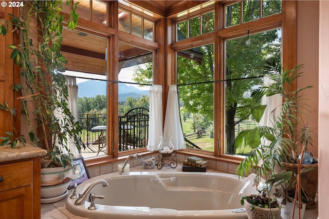 bathroom with vanity, plenty of natural light, and a tub