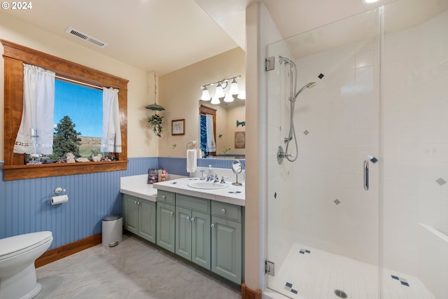 bathroom with vanity, toilet, and an enclosed shower