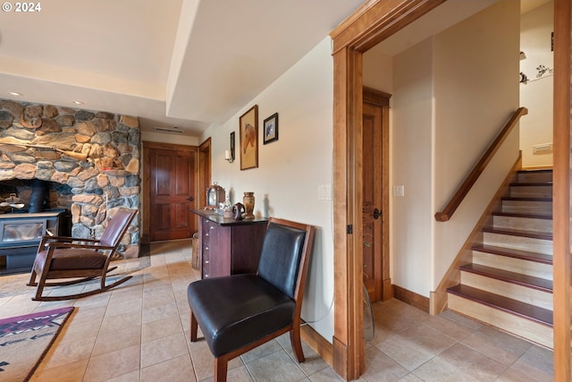 interior space with a fireplace and light tile patterned floors