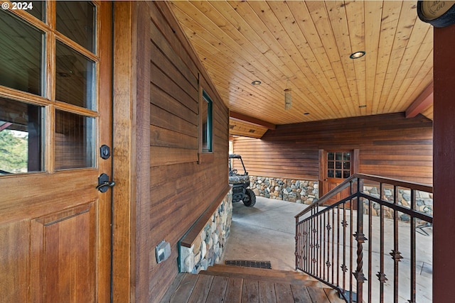 interior space with wood ceiling, wooden walls, and hardwood / wood-style floors