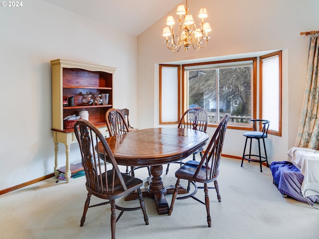 carpeted dining room with a chandelier and lofted ceiling