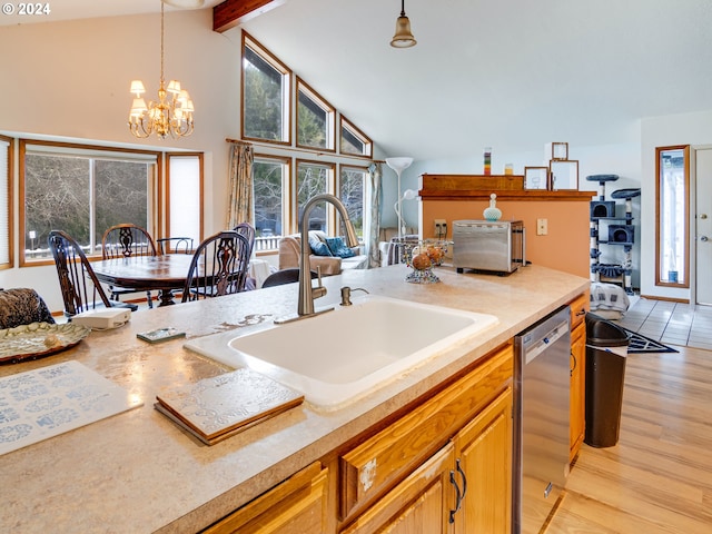 kitchen featuring dishwasher, sink, light hardwood / wood-style flooring, a notable chandelier, and pendant lighting