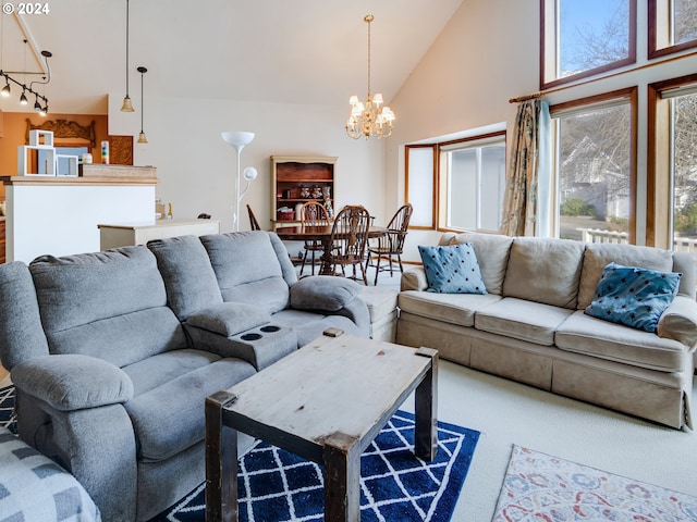 living room featuring high vaulted ceiling and a chandelier