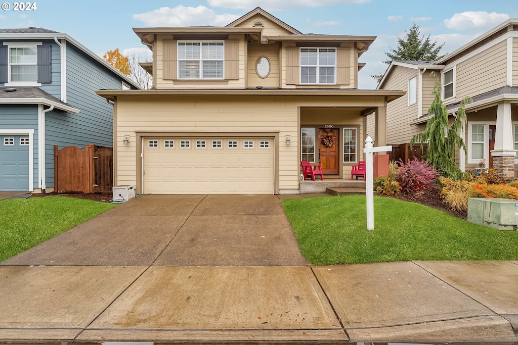 view of front of home with a garage and a front lawn