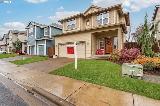 view of front of property with a front yard and a garage