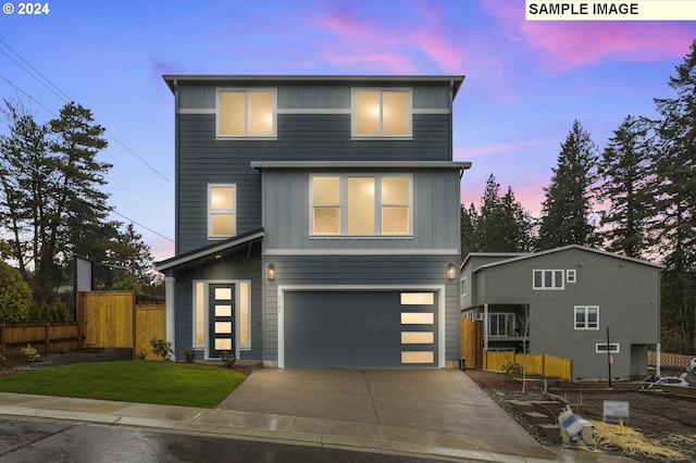 contemporary home with a lawn and a garage