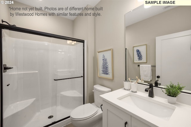 bathroom featuring vanity, an enclosed shower, and toilet