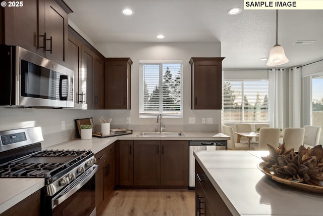 2236 Ash St Unit 21, Woodland, WA 98674 - kitchen featuring appliances with stainless steel finishes, a sink, plenty of natural light, light countertops, and recessed lighting