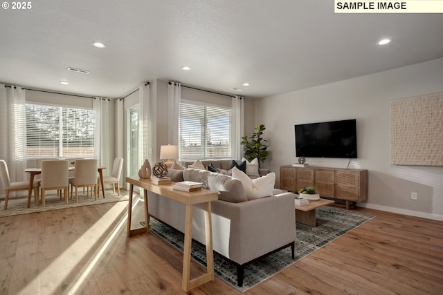 2236 Ash St Unit 21, Woodland, WA 98674 - living area with wood finished floors, healthy amount of natural light, baseboards, and recessed lighting