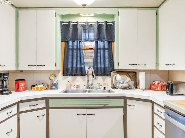 kitchen featuring sink and white cabinets