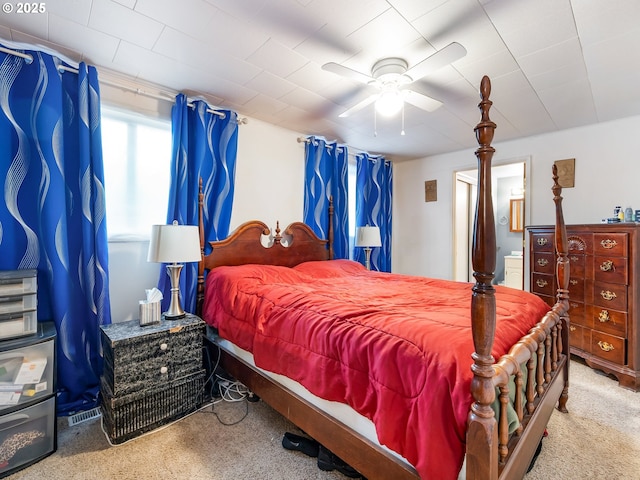 bedroom featuring ceiling fan and light carpet