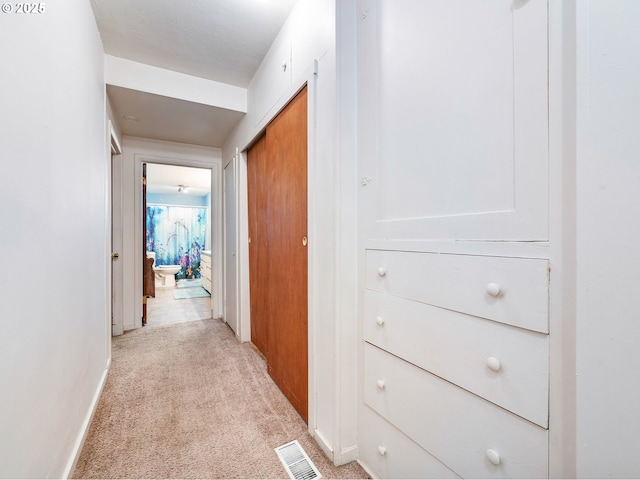 hallway featuring light colored carpet