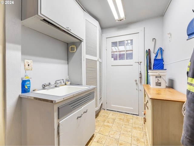 kitchen with white cabinetry and sink