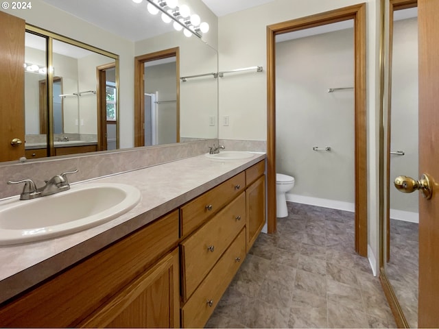 bathroom featuring an enclosed shower, vanity, and toilet