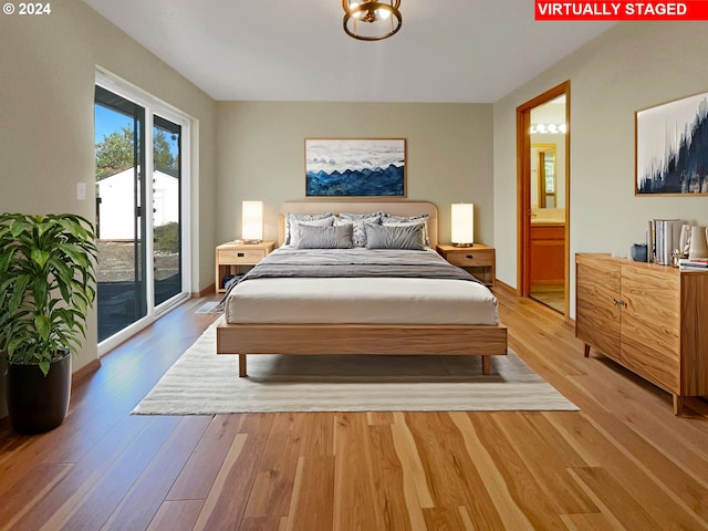 bedroom featuring access to exterior, hardwood / wood-style flooring, and ensuite bath