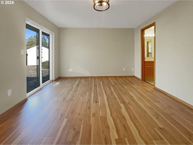 spare room with light hardwood / wood-style floors