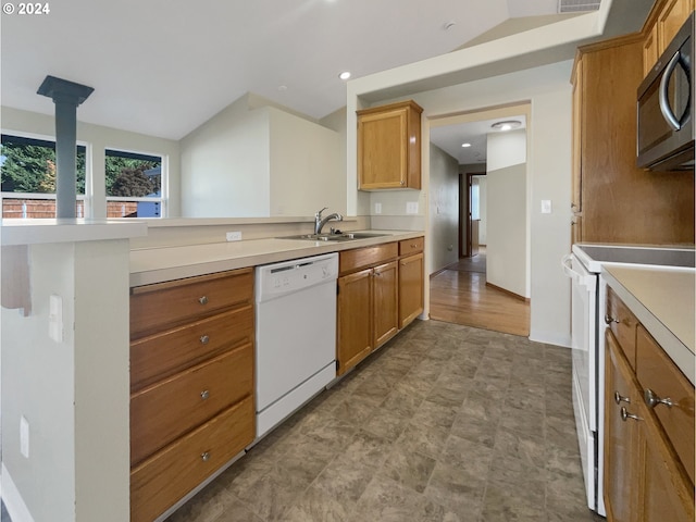 kitchen featuring kitchen peninsula, white appliances, sink, and light hardwood / wood-style flooring