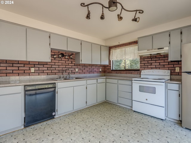 kitchen with light tile patterned flooring, sink, white appliances, and gray cabinetry