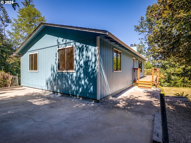 view of side of home featuring a patio area and a deck