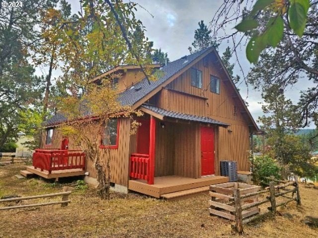 back of house featuring a wooden deck