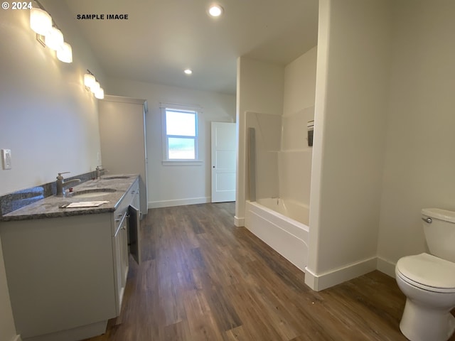 full bathroom with hardwood / wood-style floors, vanity, toilet, and plus walk in shower