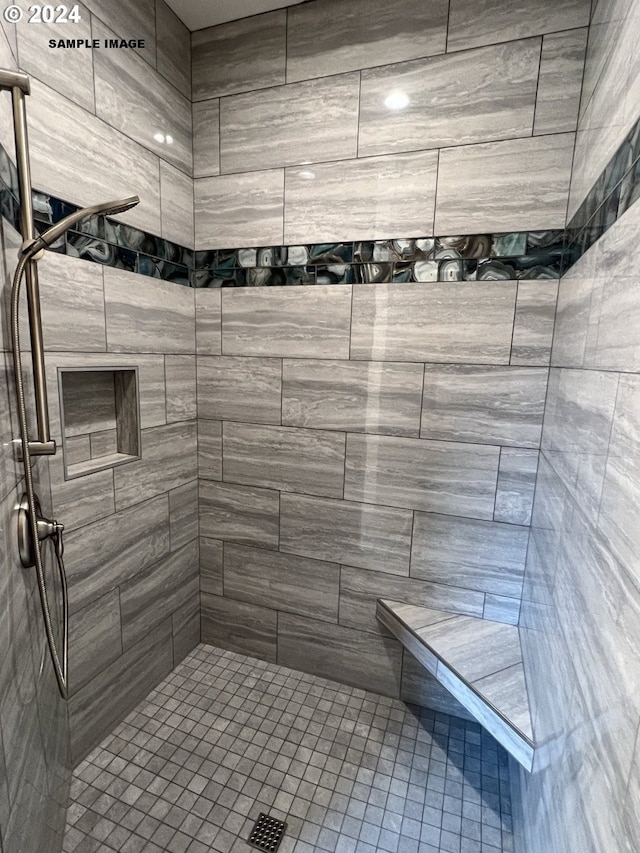 bathroom with a tile shower